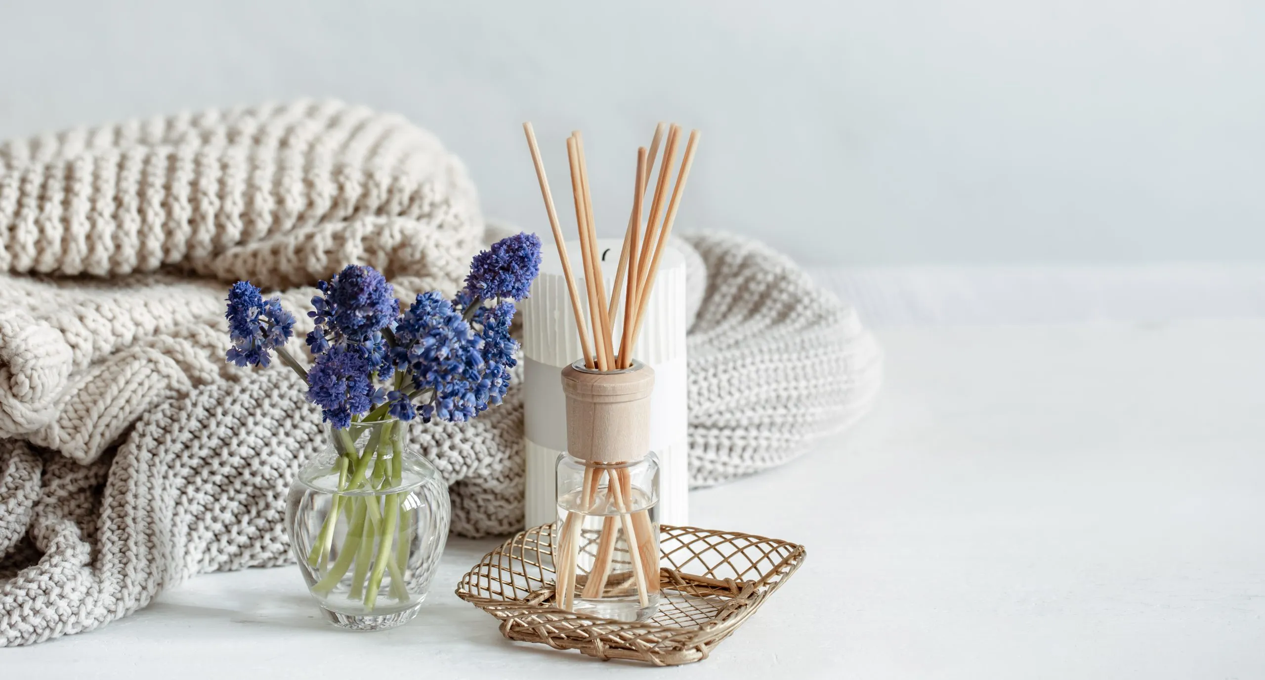 spring home composition with flowers aroma sticks knitted element copy space scaled